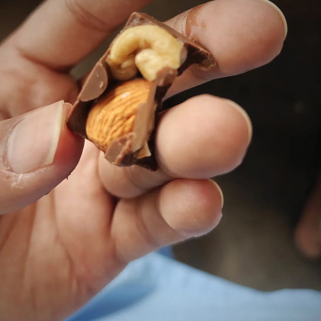 A crownX cube cut open to reveal whole almond and cashew